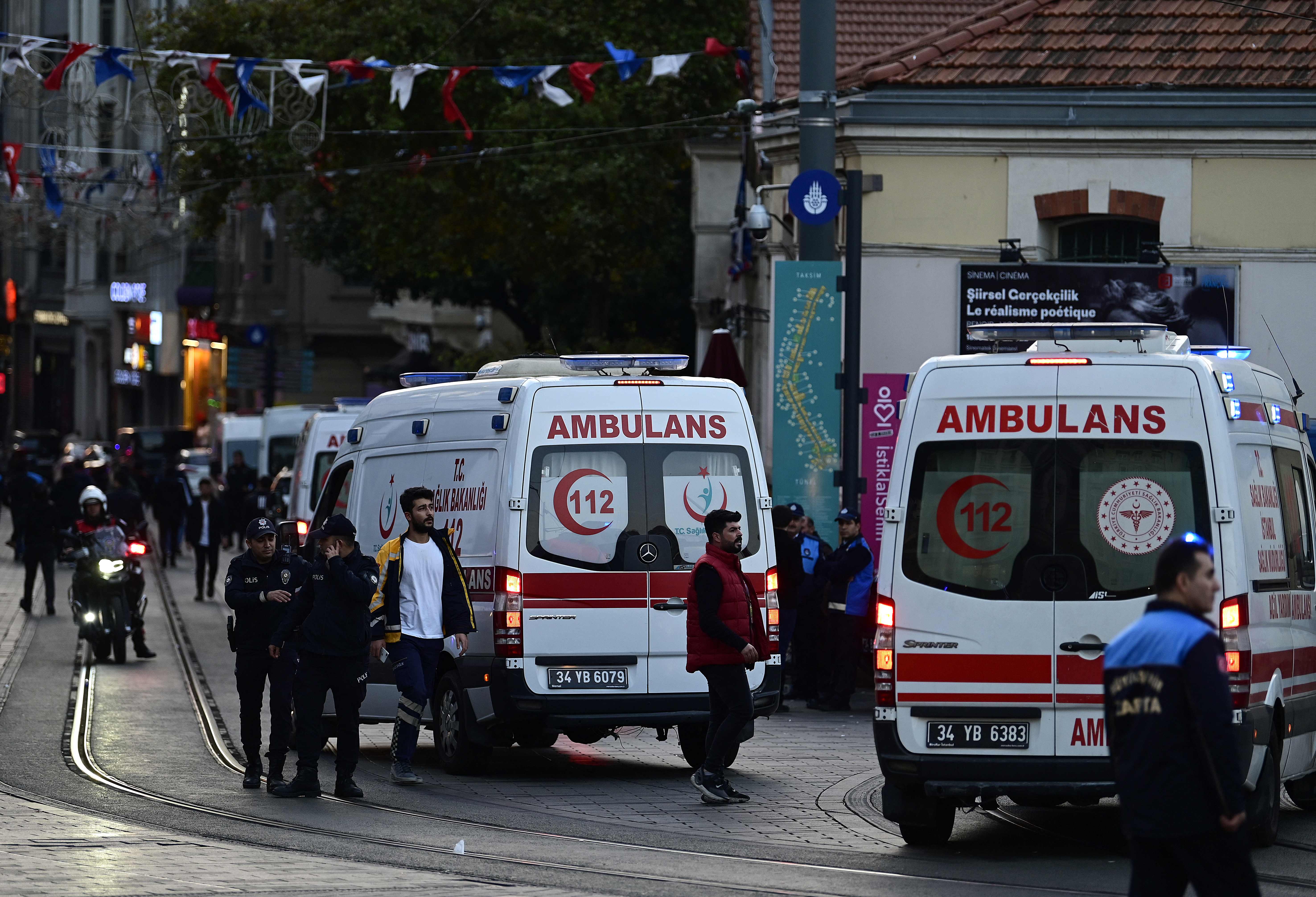 Ambulances line up as Turkish policemen try to secure the area after a strong explosion of unknown origin shook the busy shopping street of Istiklal in Istanbul, on November 13, 2022. (AFP photo by Yasin Akgul)